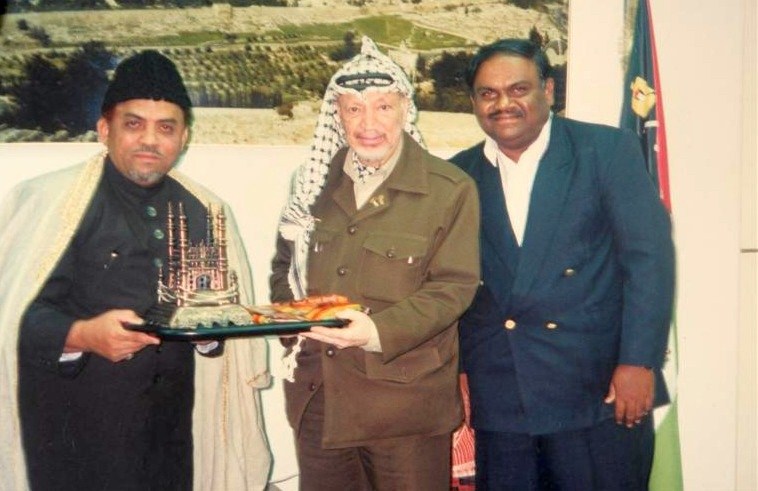 Presenting a model of a mosque to Yasser Arafat, President of Palestine