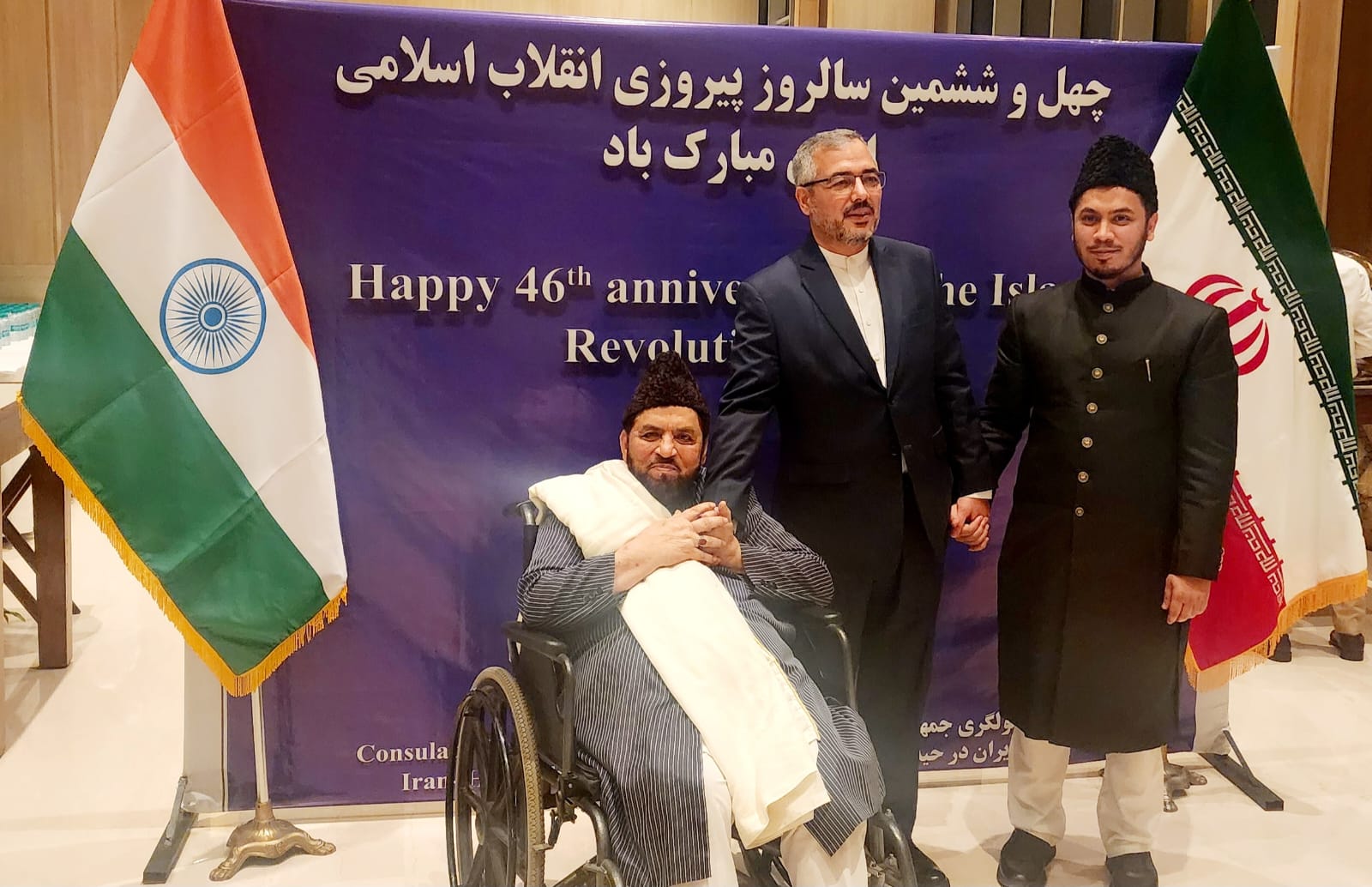 With the Consul General of Iran and Dr. Syed Murtuza Naqshbandi beneath the flags of India and Iran, 46th National Day of Iran, Hyderabad